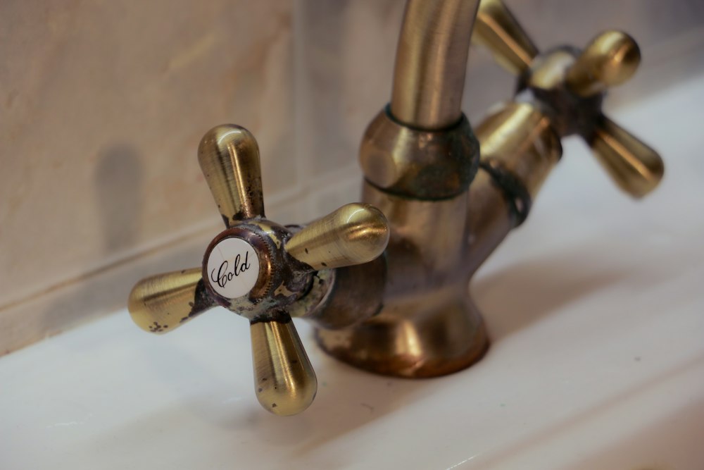 Antique brass basin tap with cross-head handles