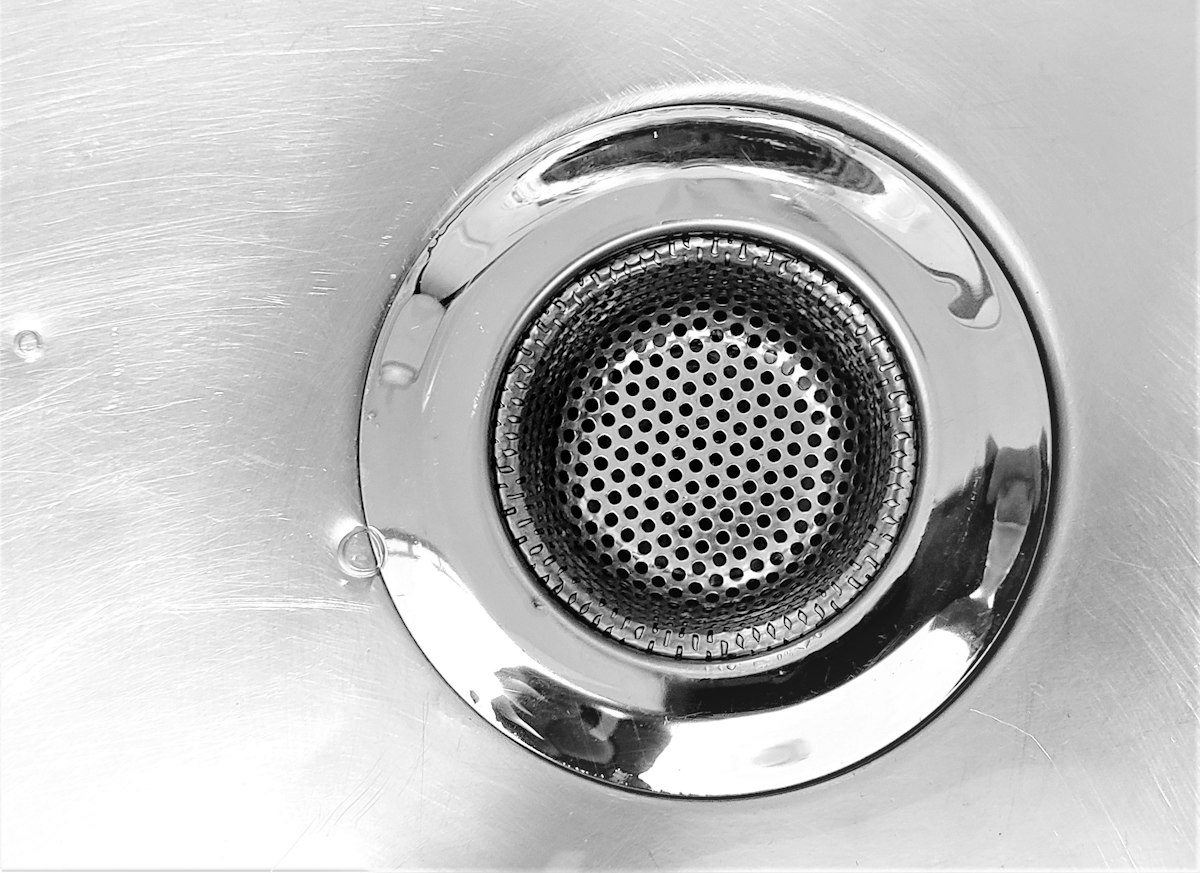 Close-up of a metal basin drain