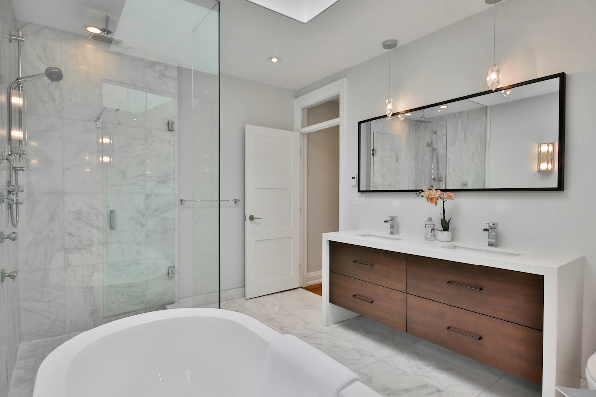 Large white bathtub beside a walk-in shower