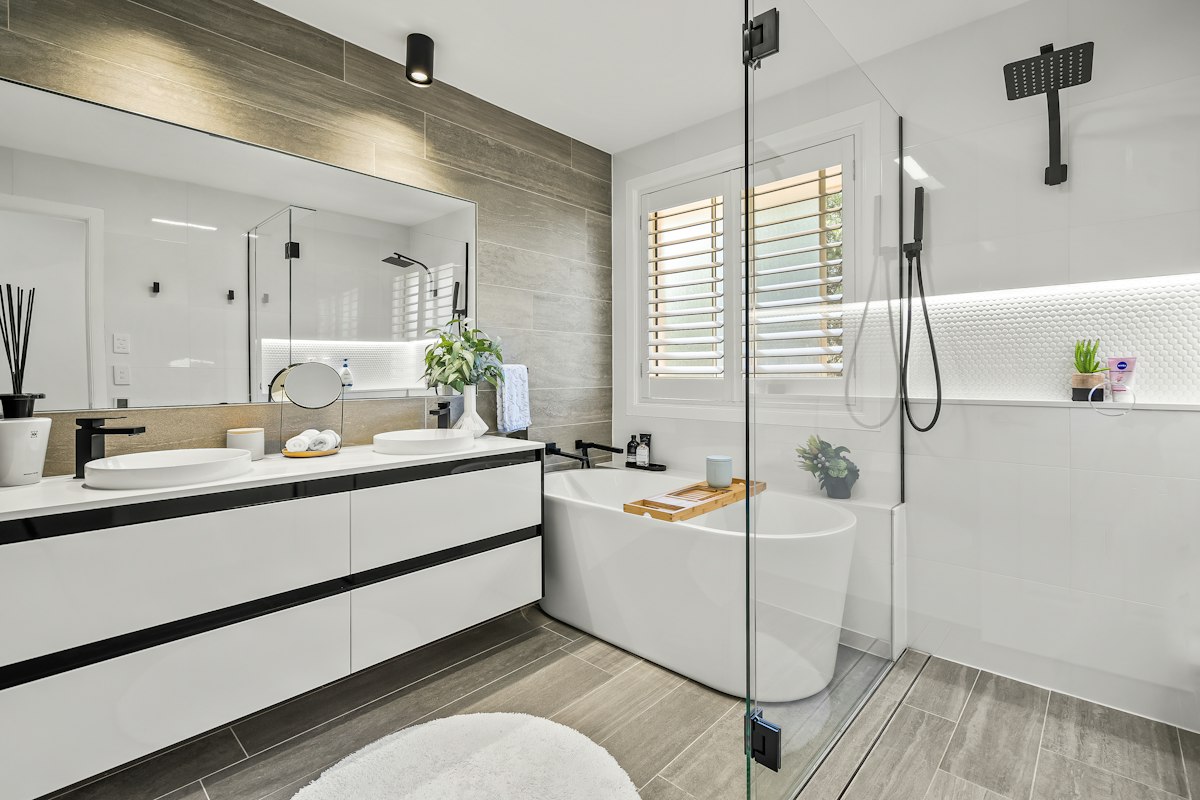 Luxury bathroom with double vanity, glass shower and freestanding bath