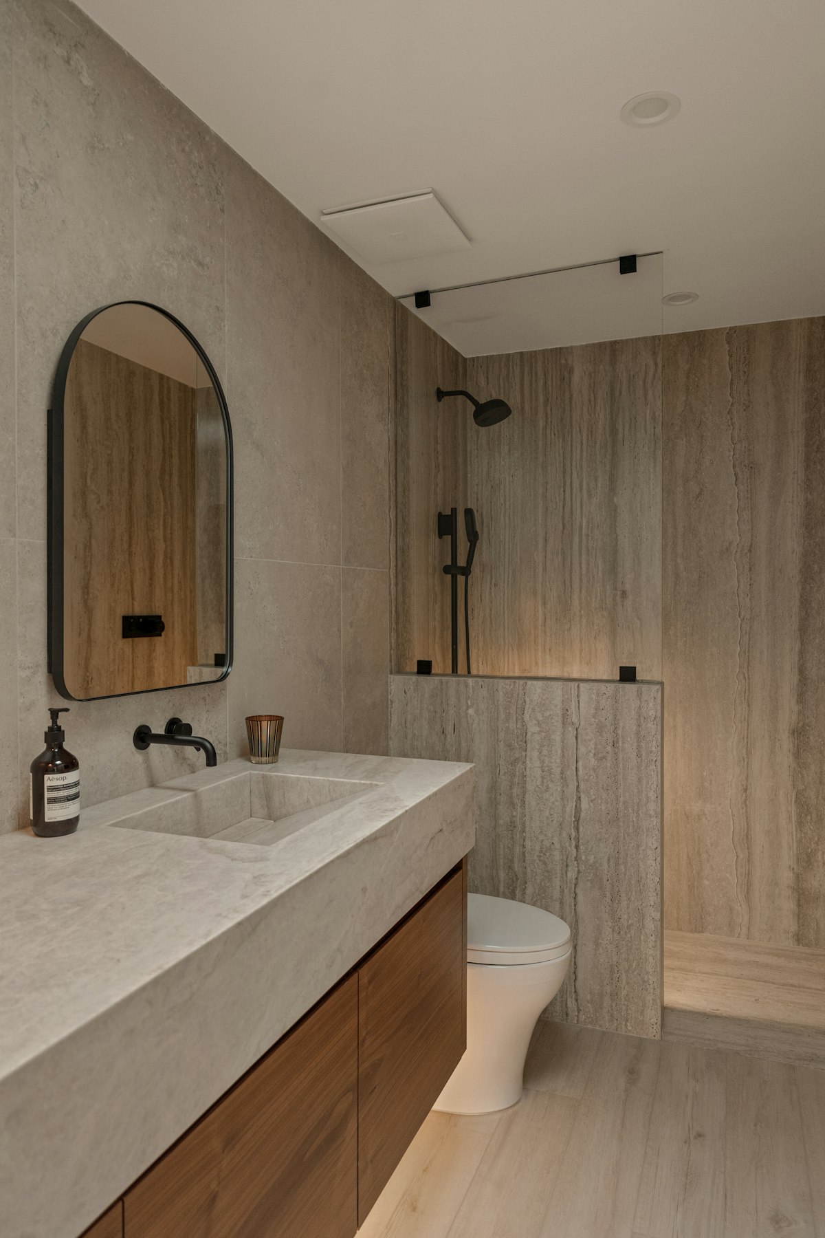 Bathroom with stone wall tiles and wooden vanity
