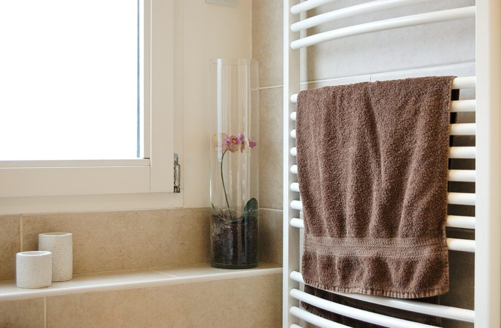 Towel hanging on a white heated towel rail